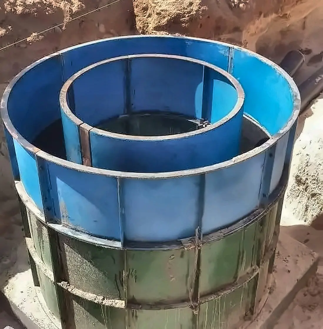 Circular steel formwork set up to cast a manhole chamber