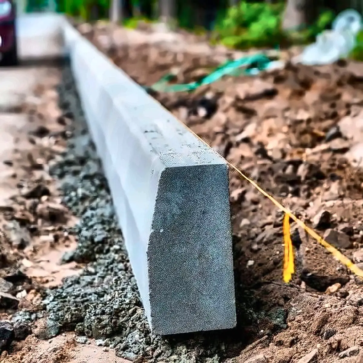 Precast concrete kerb set to a string line